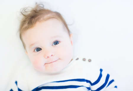 Funny baby in a striped navy shirt の写真素材