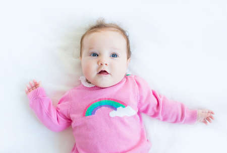 Sweet baby girl in a knitted sweater の写真素材