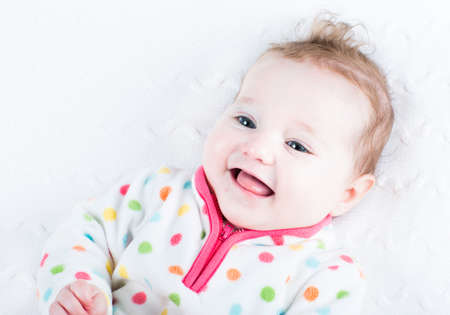 Laughing baby girl showing her tongue の写真素材