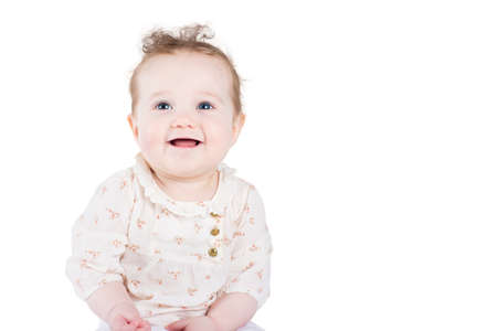 Beautiful baby girl with curly hair in an elegant shirt, isolated on white の写真素材