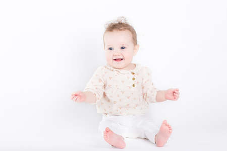 Beautiful baby girl in an elegant shirt and pants 