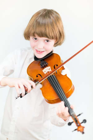 Happy child playing violin の写真素材