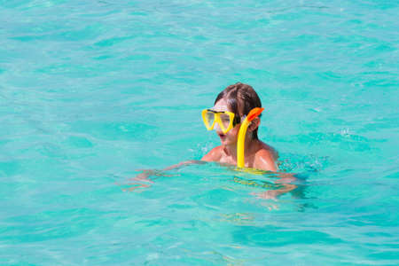 Little boy snorkeling on a tropical beach の写真素材