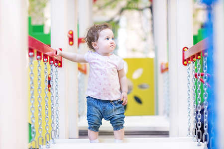 Sweet little girl climbing on a playground の写真素材