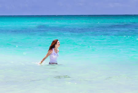 Young beautiful woman swimming in the ocean の写真素材