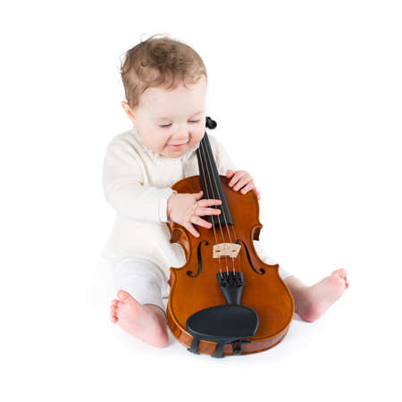 Funny little baby playing violin の写真素材