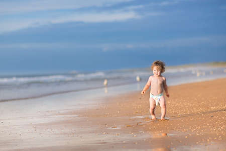 Cute school boy riding a bike in a beautiful summer park の写真素材