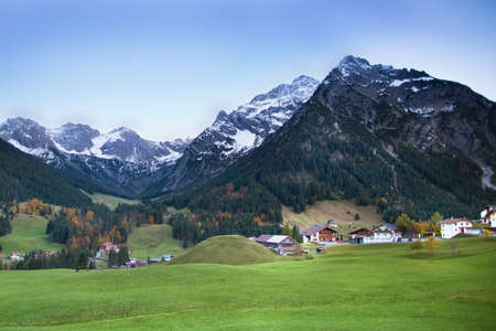 Beautiful little village between snow covered mountains の写真素材