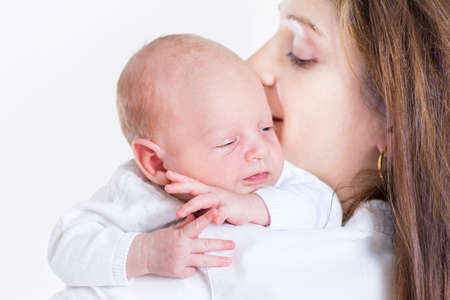 Cute funny newborn baby sleeping on his mother s shoulder 