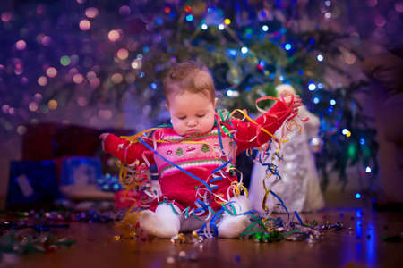 Baby under Christmas treeの写真素材