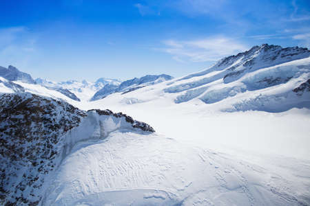Aerial view of the Alps mountains in Switzerland. View from helicopter in Swiss Alps.の写真素材
