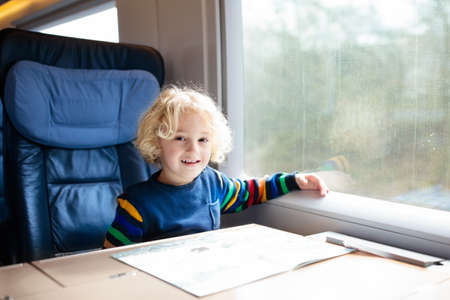 Child traveling by train. Little kid in a high speed express train on family vacation in Europe....