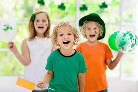 Family celebrating St. Patrick's Day. Irish holiday, culture and tradition. Kids wear green...