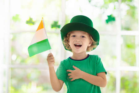 Family celebrating St. Patrick's Day. Irish holiday, culture and tradition. Kids wear green...