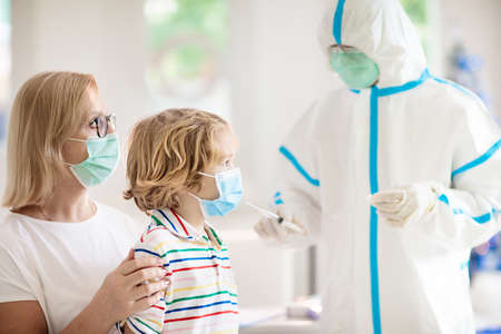 vaccine injection for kid at doctor office. Child  vaccination in hospital. Doctor in protective...