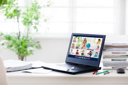 Online remote learning. Computer screen with video conference chat of student class group and...