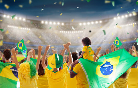 Brazil football supporter on stadium. Brazilian fans on soccer pitch watching team play. Group of supporters with flag and national jersey cheering for Brazil. championship game.の写真素材
