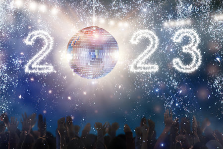 2023 New Year disco party in a night club. Glowing numbers lantern disco ball. Group of friends...