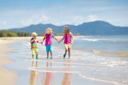 Child playing on tropical beach. Little girl digging sand at sea shore. Family summer holidays. Kids play with water and sand toys. ocean and island fun. Travel with young children. Asia holiday.の写真素材