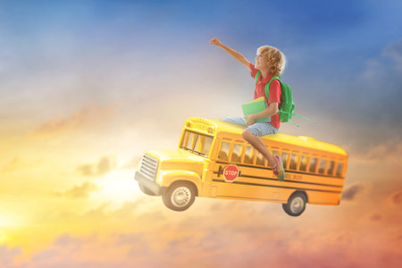 Child going back to school. Boy flying on school bus. Imagination and creative mind. Happy little...