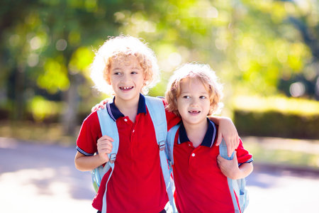 Children go back to school. Start of new school year after summer vacation. Boy and girl with backpack and books on first school day. Beginning of class. Education for kindergarten and preschool kids.の写真素材