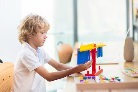 Child with educational toys in school. Science class or robotics club for young students. Little boy with mathematics puzzle game toy. Fun lesson for little kids.の写真素材