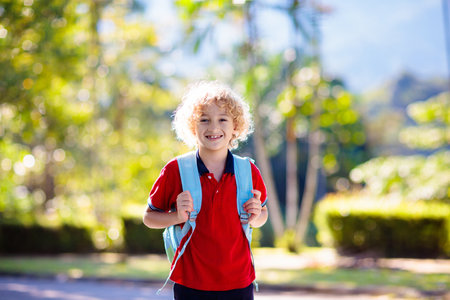 Children go back to school. Start of new school year after summer vacation. Boy with backpack and books on first school day. Beginning of class. Education for kindergarten and preschool kids.の写真素材