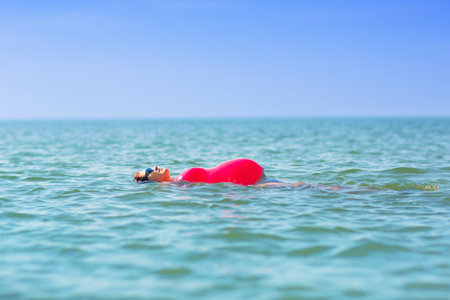 Pregnant woman on the beach. Healthy and active pregnancy.  Young expecting mom on tropical vacation...