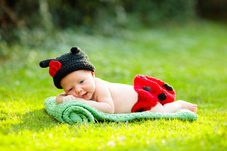 Baby in cute dress up costume. Newborn in garden. Adorable infant napping in summer park.の写真素材
