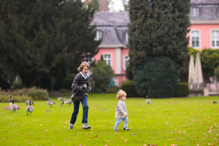 Children hiking in forest and mountains. Kids play outdoor in summer. Little boy and girl on hike trail in national park. Outdoor fun and healthy activity.の写真素材
