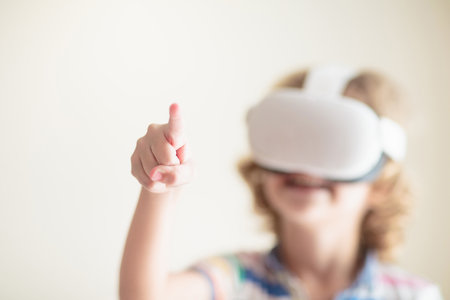 Child in virtual reality goggles. VR set for kids. Little boy playing computer game. Learning with modern digital device. Kids study using electronic gadget. Future studying concept. Fun gaming.の写真素材