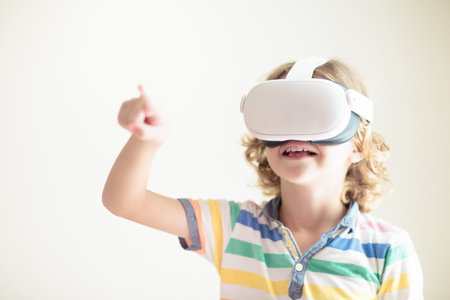 Child in virtual reality goggles. VR set for kids. Little boy playing computer game. Learning with modern digital device. Kids study using electronic gadget. Future studying concept. Fun gaming.の写真素材