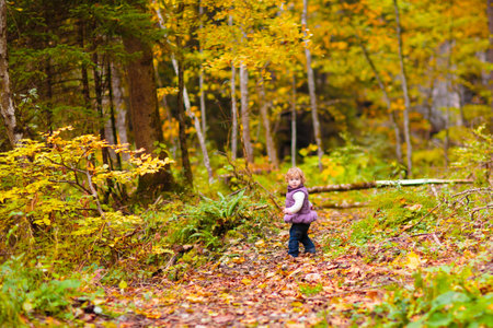 Family with kids hiking in the mountains. Young mother and children hike in beautiful Alps mountain landscape. Trekking and camping with young child. Outdoor adventure.の写真素材