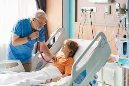 Sick child in hospital room. Kid in clinic ward. Little boy with oxygen tube and IV line in hospital bed. Pediatrician doctor examining patient. Family health care and insurance. Medicine for children.の写真素材