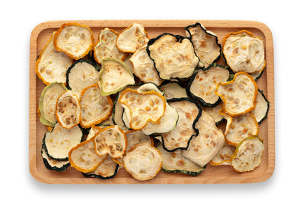 Dried zucchini slices on wooden tray on white background, flat lay. Save with adding the clipping pathの写真素材