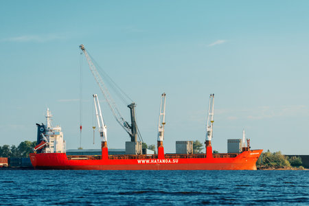 12/04/2016, Arkhangelsk, Russia, cargo ship "Nikifor Begichev" with cranes is docked at river portの写真素材