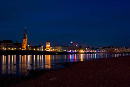 historical city of duesseldorf and rhine at nightの写真素材