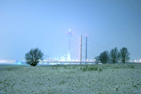düsseldorf media harbour and tv tower at night with winterly floodの写真素材