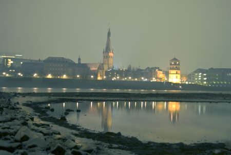 historical city of düsseldorf at night - rhine promenade seen from other side of the riverの写真素材