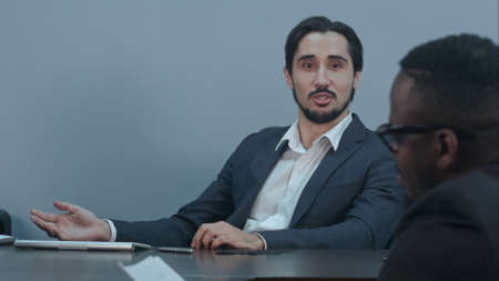 Hispanic latin businessman communicating with afro american partner in the Office