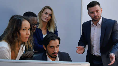 Team of happy business people posing for photographer around the deskの写真素材