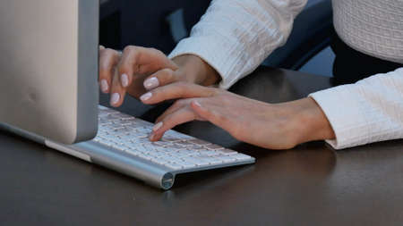 Female hands typing at office