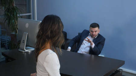 Smiling business man talking with his colleague during an informal meeting at office. Professional...