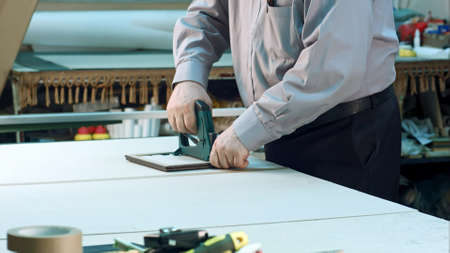 Senior worker finishing frame in workshop. Close up. Professional shot in 4K resolution. 083. You...