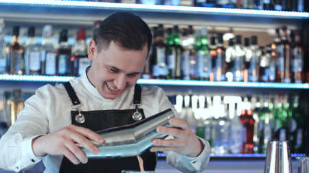 Expert barman is making cocktail at night clubの写真素材
