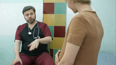 Female doctor consulting a pregnant woman in the hospitalの写真素材