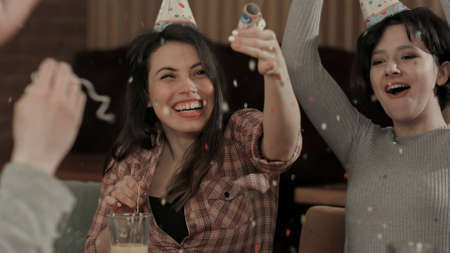 Young people throwing confetti celebrating birthdayの写真素材