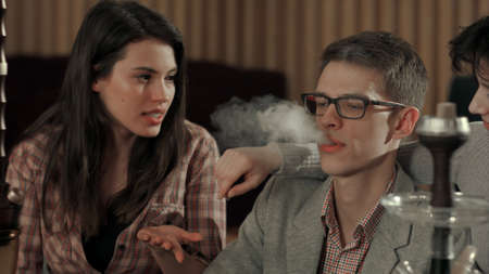 Man smoking hookah and coughing