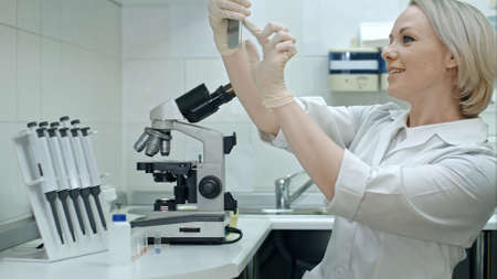 Attractive doctor hav taking selfie photo on cellphone at modern laboratoryの写真素材