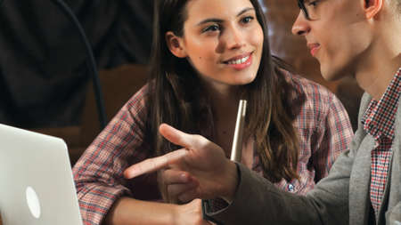 Beautiful young couple working on laptop in a shisha barの写真素材